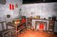China: Kitchen area with family shrine on the floor in a traditional Chinese home in the recreated village within the Dr. Sun Yatsen Residence Museum, Cuiheng, Guangdong Province